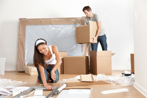 Professional movers carrying furniture during a house move in Enfield