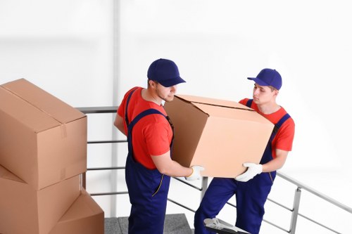 Professional movers handling boxes and furniture during an Enfield relocation