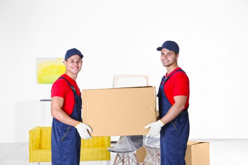 Removal team packing and lifting items during a safe house move