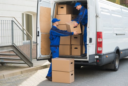Removal worker carrying furniture carefully during an Enfield move