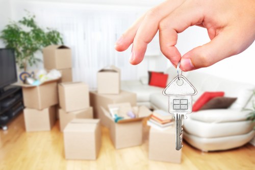 Movers carrying furniture through a residential property in Enfield