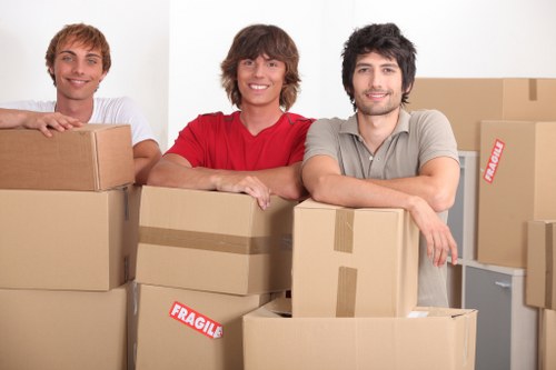 Packed moving boxes and furniture ready for collection in Enfield