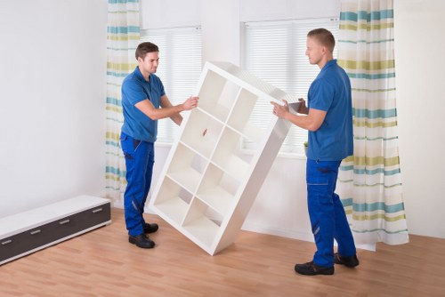 Trained removal staff carrying furniture with protective equipment