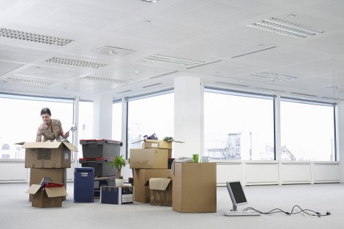 Packed office equipment and labelled boxes for an Enfield business move